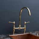 AquaPrime brass bridge faucet – side view showing curved legs