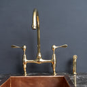 AquaPrime brass bridge faucet – close-up of natural unlacquered finish