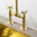 Unlacquered brass bridge faucet modern – side view with natural patina