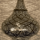 Brass pierced pendant light – hanging in living room with warm glow