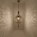 Tall brass teardrop pendant light hanging in boho living room – Brass For Homes