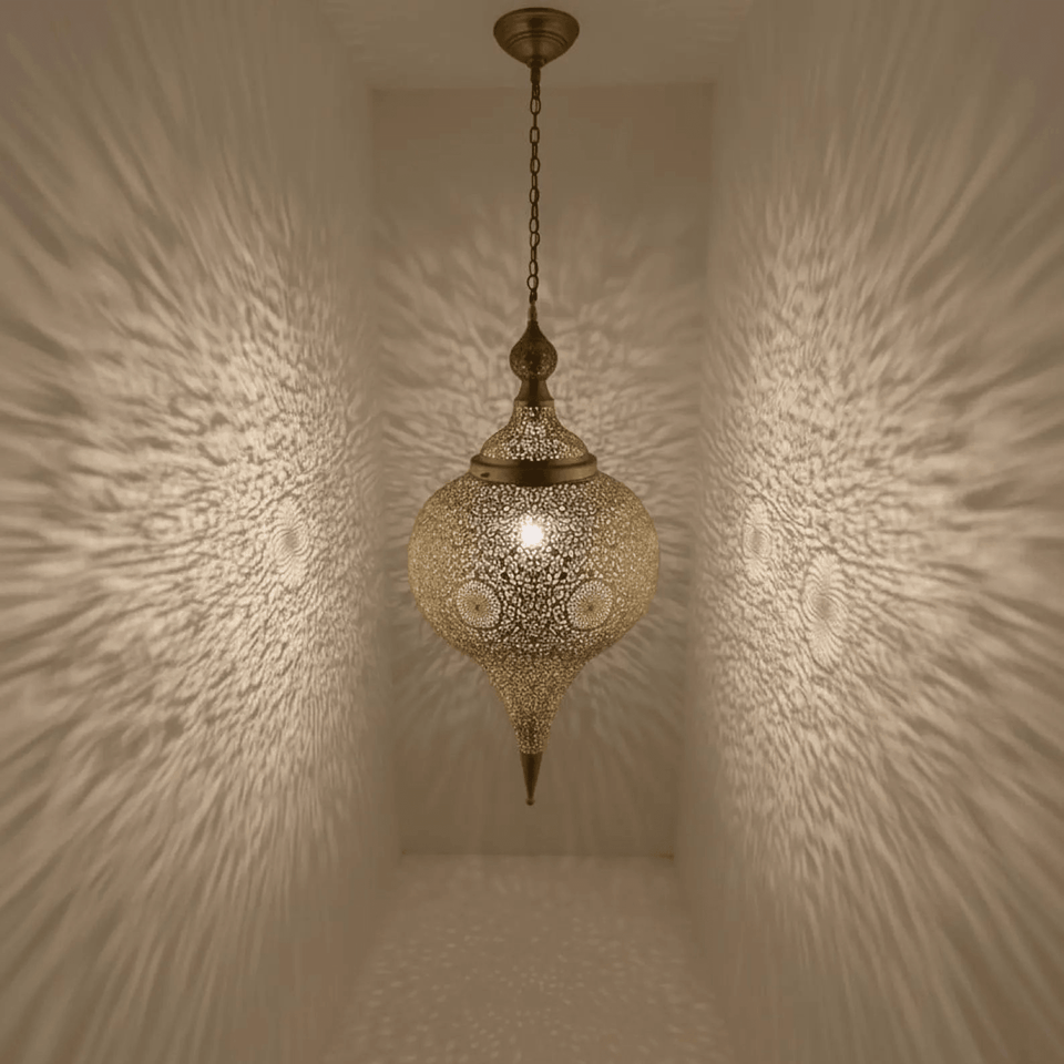 Tall brass teardrop pendant light hanging in boho living room – Brass For Homes