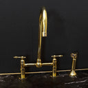 Unlacquered brass bridge faucet lever handles – installed in kitchen