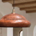 Rustic copper pendant light illuminated warm glow above kitchen counter – Brass For Homes