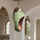 Close-up of oval cutout copper pendant with hand-applied green patina — Brass For Homes