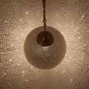 Pierced brass globe ceiling lamp casting intricate shadow patterns – Brass For Homes