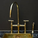 Unlacquered brass 3-hole bridge kitchen faucet with lever handles installed in kitchen – Brass For Homes