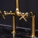 Unlacquered brass bridge faucet polished – installed in kitchen